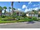 One story home with manicured lawn and tropical landscaping at 811 Riviera Dunes Way, Palmetto, FL 34221