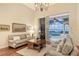 Living room with hardwood floors, sofas, coffee table, and pool view at 811 Riviera Dunes Way, Palmetto, FL 34221