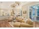 Bright and airy living room with hardwood floors, comfortable seating and access to outdoor patio at 811 Riviera Dunes Way, Palmetto, FL 34221