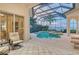 Enclosed pool and spa area with seating and water views at 811 Riviera Dunes Way, Palmetto, FL 34221
