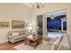Living room with hardwood floors, sofas, coffee table, and pool view at 811 Riviera Dunes Way, Palmetto, FL 34221