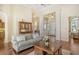 Open living room with hardwood floors, neutral decor and views to entryway at 811 Riviera Dunes Way, Palmetto, FL 34221