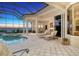 Evening view of a luxurious pool and spa with lounge chairs at 811 Riviera Dunes Way, Palmetto, FL 34221