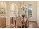 Elegant dining room with hardwood floors, built-in cabinetry, and a lovely chandelier at 811 Riviera Dunes Way, Palmetto, FL 34221