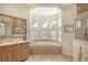 Bathroom with soaking tub and large vanity at 811 Riviera Dunes Way, Palmetto, FL 34221