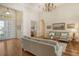Living room with hardwood floors, neutral-toned sofas and a large window at 811 Riviera Dunes Way, Palmetto, FL 34221