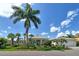 Single-Gathering home with lush landscaping and palm trees at 811 Riviera Dunes Way, Palmetto, FL 34221