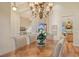 Formal dining room with hardwood floors, a chandelier, and views into the kitchen at 811 Riviera Dunes Way, Palmetto, FL 34221
