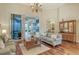 Bright living room with hardwood floors, comfy seating, and access to a relaxing patio at 811 Riviera Dunes Way, Palmetto, FL 34221