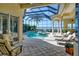 Inviting pool and spa area with a screened enclosure and tranquil water views at 811 Riviera Dunes Way, Palmetto, FL 34221