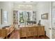 Bright home office with built-in shelving and hardwood floors at 811 Riviera Dunes Way, Palmetto, FL 34221