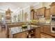 Eat-in kitchen with granite countertops and custom wood cabinetry. View of the pool and lanai at 811 Riviera Dunes Way, Palmetto, FL 34221