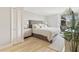 Main bedroom with plush bed and light, airy decor at 4822 Ocean Blvd # 4D, Sarasota, FL 34242