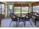 Bright sunroom featuring wicker patio furniture and backyard access at 3423 52Nd Avenue W Cir # 267, Bradenton, FL 34210