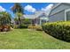 Well-manicured lawn and tropical landscaping enhance curb appeal at 3423 52Nd Avenue W Cir # 267, Bradenton, FL 34210