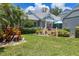 Well-maintained front yard with lush landscaping and flamingo decor at 3423 52Nd Avenue W Cir # 267, Bradenton, FL 34210