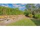Landscaped backyard with retaining wall and greenery at 360 N Point Rd, Osprey, FL 34229