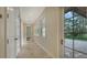 Light-filled hallway with tile flooring, leading to backyard access at 360 N Point Rd, Osprey, FL 34229