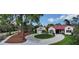 Property showcasing circular driveway, landscaping, and street view at 360 N Point Rd, Osprey, FL 34229