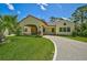 Front view of charming Spanish style home with a covered entryway at 360 N Point Rd, Osprey, FL 34229