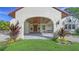 Covered entry with brick pavers, ornate lighting, and lush landscaping at 360 N Point Rd, Osprey, FL 34229