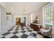 Reception area with a checkered floor, wooden furniture, and large windows at 360 N Point Rd, Osprey, FL 34229