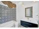 Bathroom with patterned tile, floating vanity and decorative mirror at 360 N Point Rd, Osprey, FL 34229