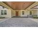 Covered entryway with wood-beamed ceiling and elegant lighting fixtures at 360 N Point Rd, Osprey, FL 34229