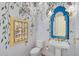 Unique powder room with decorative wall mural, blue mirror, and pedestal sink at 360 N Point Rd, Osprey, FL 34229