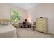 Cozy bedroom with a single bed, dresser, and workspace at 5249 Far Oak Cir, Sarasota, FL 34238