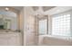 Elegant bathroom with a large walk-in shower, bathtub, and double vanity at 5249 Far Oak Cir, Sarasota, FL 34238