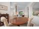 Bright dining area with an oval wooden table and beige chairs at 5249 Far Oak Cir, Sarasota, FL 34238
