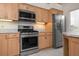 Kitchen features stainless steel appliances and light wood cabinets at 5249 Far Oak Cir, Sarasota, FL 34238