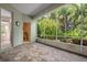 Spacious screened porch with brick pavers and access to a private bathroom at 5249 Far Oak Cir, Sarasota, FL 34238