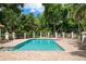 Community pool with lounge chairs and lush landscaping at 5249 Far Oak Cir, Sarasota, FL 34238