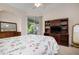 Spacious bedroom with a large bed, dresser, and access to a private patio at 5249 Far Oak Cir, Sarasota, FL 34238