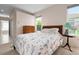 Bedroom with floral bedding, dresser, and access to bathroom at 5249 Far Oak Cir, Sarasota, FL 34238