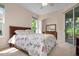 Bright bedroom with floral bedding and access to a private patio at 5249 Far Oak Cir, Sarasota, FL 34238