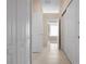 Bright hallway with neutral tile floors and access to multiple rooms at 5249 Far Oak Cir, Sarasota, FL 34238
