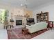 Living room with fireplace, built-in shelving, and a comfortable sofa at 5249 Far Oak Cir, Sarasota, FL 34238