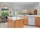 Spacious kitchen with island, stainless steel appliances, and light wood cabinets at 5249 Far Oak Cir, Sarasota, FL 34238