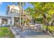 Inviting backyard deck area with wooden furniture, lush landscaping, and external staircase to the second floor at 508 65Th St, Holmes Beach, FL 34217
