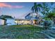 Expansive backyard with outdoor seating, a large deck, and lush greenery at 508 65Th St, Holmes Beach, FL 34217