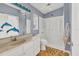 Bathroom featuring a walk-in shower, single vanity, and colorful tile flooring at 508 65Th St, Holmes Beach, FL 34217
