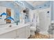 Bright, nautical-themed bathroom with blue walls, a clean white vanity, and a shower, creating a cheerful space at 508 65Th St, Holmes Beach, FL 34217