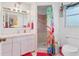 Bright bathroom features a vanity, a shower with colorful curtain, and themed decor at 508 65Th St, Holmes Beach, FL 34217