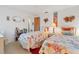 Cozy bedroom has twin beds with bright seashell bedding, a ceiling fan, and decorative ocean themed accents at 508 65Th St, Holmes Beach, FL 34217