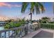 Spacious deck offers a view of the tranquil canal and surrounding palm trees at 508 65Th St, Holmes Beach, FL 34217