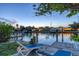 Dockside view with chairs, overlooking serene canal waters at dusk at 508 65Th St, Holmes Beach, FL 34217