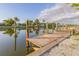 Beautiful view of the wooden dock stretching into the calm water with concrete supports at 508 65Th St, Holmes Beach, FL 34217